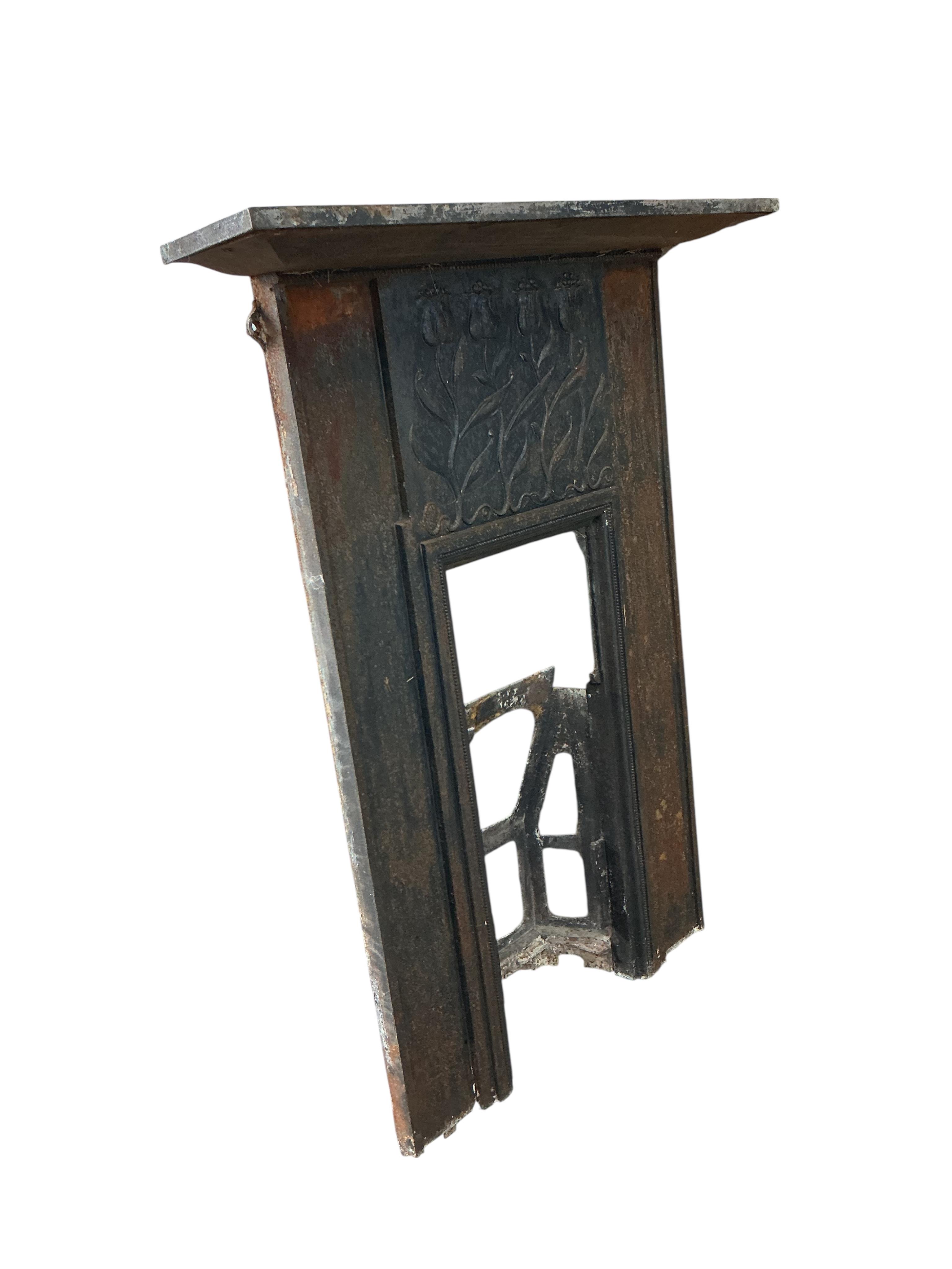A late Victorian Art Nouveau cast iron fire surround, with tulip design, width 94cm, height 126cm